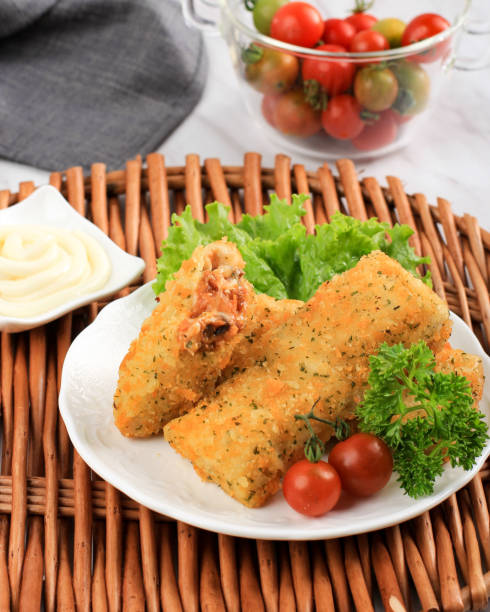 Fried Risoles or Risol Vegetable are Indonesian snacks. Served with Mayonaise Sauce. Served with Bamboo Tray, Ceramic Plate with Tomato
