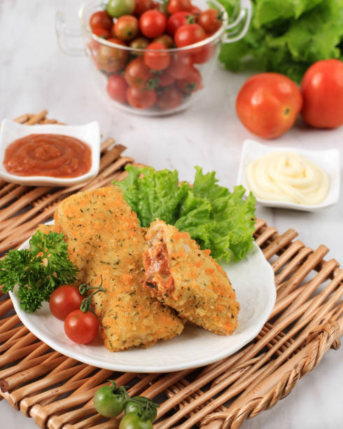 Indonesian Snacks: Fried Risoles or Risol Vegetable with Minced Meat. Served with Chili Sauce and Mayonaise, Garnish with Fresh Parsley.