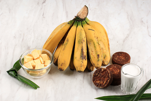 Ingredient Preparation making Banana and Sweet Potato Compote (Kolak Pisang Ubi). Ripe Banana, Sweet Potato, Palm Sugar (Gula Merah), Pandan Leaves, and Coconut Milk. Popular for Ramadan Breakfast