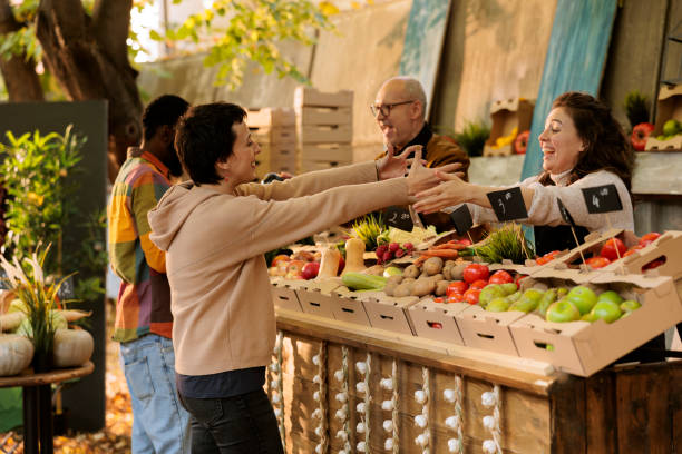 istock Vendor greets client at farm fair booth 1901458334