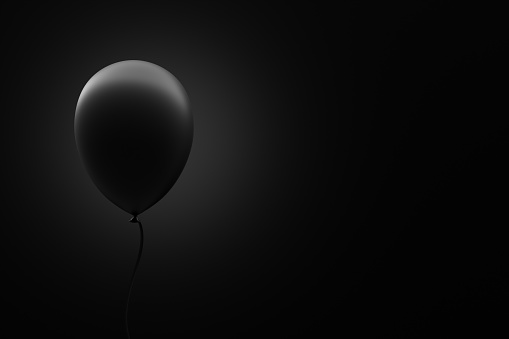 Black balloon floating in the air on black background with copy space. 3D render.