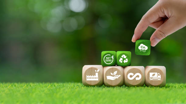 istock Carbon credit concept. neutral, balanced carbon dioxide emissions. Renewable energy to absorb carbon dioxide to offset the same amount produced. Green icon on wooden block 1901498714