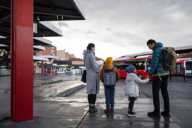 istock Happy family on bus station 1901516827