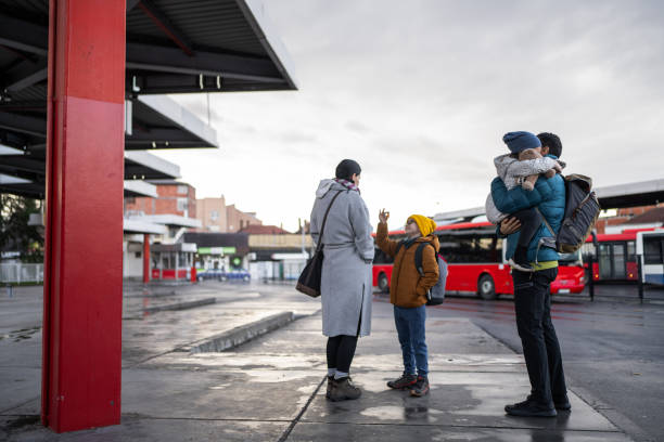 istock Happy family on bus station 1901529391