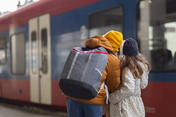 istock Little travelers on train station 1901533907