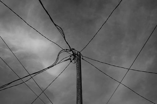 Monochrome Photography. Landscape View. Black and white Photo of electric pole with branching cables. An electricity pole with a sky background. Bandung, Indonesia