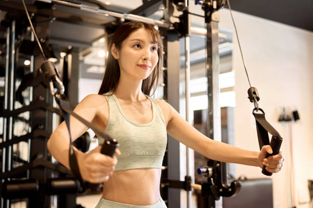 istock A woman training her upper body with a cable machine 1901584719