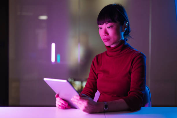 istock Asian businesswoman using technologies in modern office. Businesswoman is using digital tablet and working late in the office 1901585238