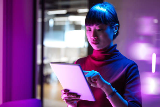 istock Asian businesswoman using technologies in modern office. Businesswoman is using digital tablet and working late in the office 1901585774