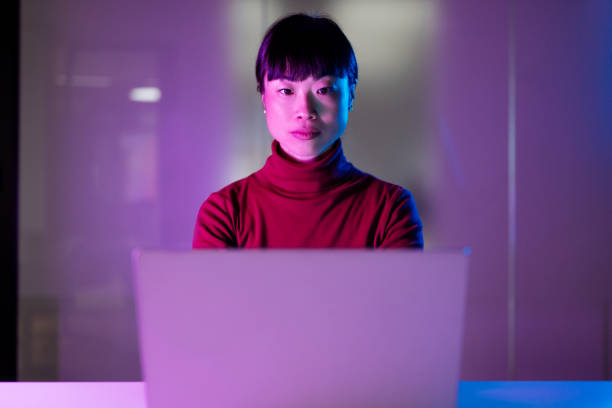 istock Serious Asian businesswoman using laptop and wireless technologies in modern office 1901585775