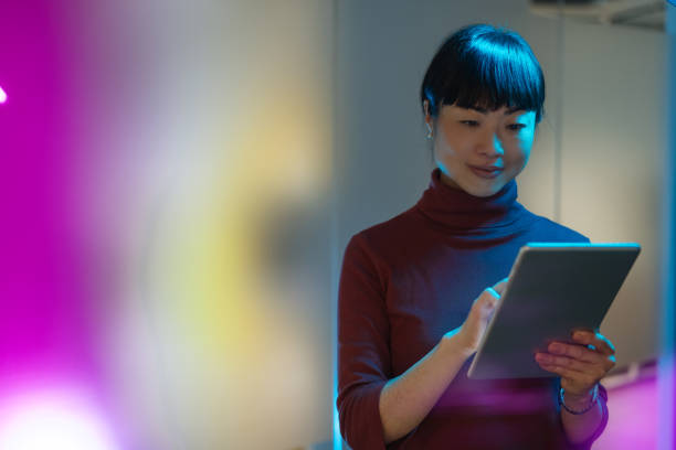 istock Asian businesswoman using technologies in modern office. Businesswoman is using digital tablet and working late in the office 1901586290