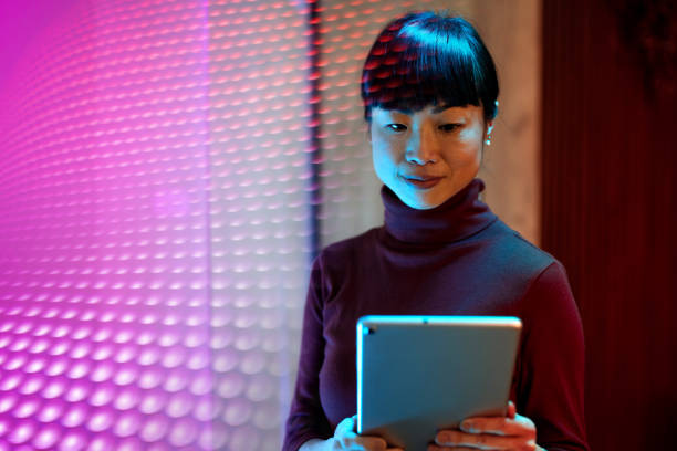 istock Asian businesswoman using technologies in modern office. Businesswoman is using digital tablet and working late in the office 1901586291