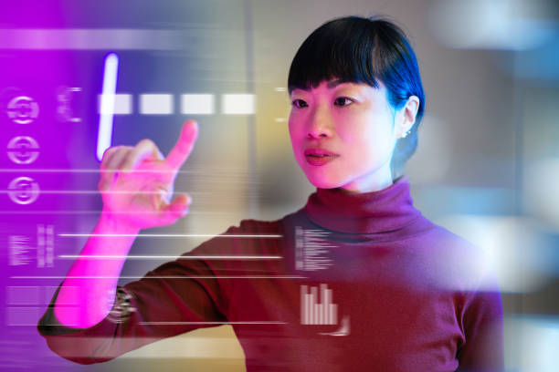 Serious Japanese businesswoman using technologies in modern office