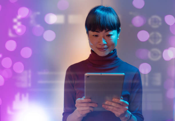 istock Asian businesswoman using technologies in modern office. Businesswoman is using digital tablet and working late in the office 1901586305