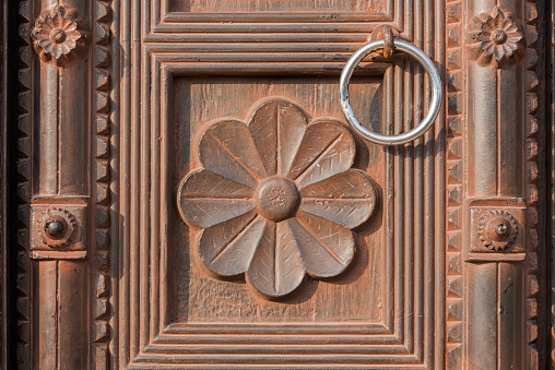 Beautiful flower carving on the wooden door. Abstract. Background. Backdrop. Wallpaper.