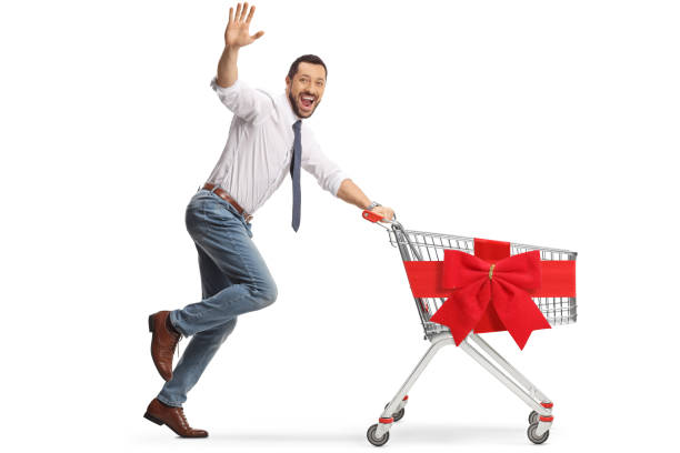 istock Man running with and empty shopping cart and waving at camera 1901608758