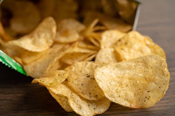 istock Potato chips, delicious spicy for crips, thin slice deep fried snack fast food in open bag. 1901630404