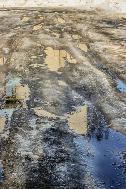 istock In the spring, the yard is covered with melting snow 1901647910