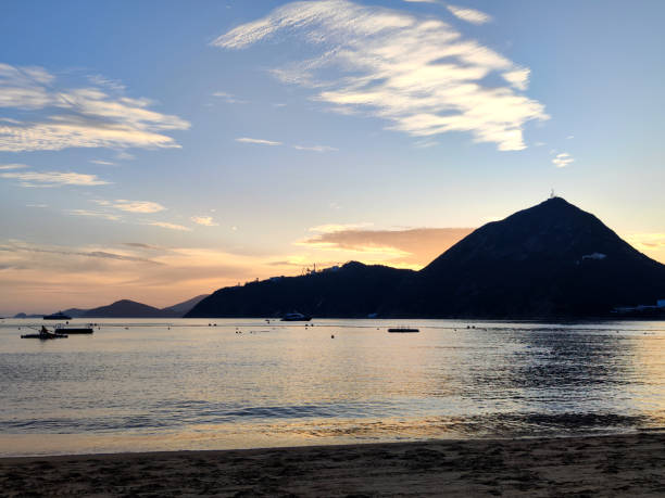Dusk over Deep Water Bay. The bay is located on the southern shore of Hong Kong Island in Hong Kong. The bay is surrounded by Shouson Hill, Brick Hill, Violet Hill and Middle Island.