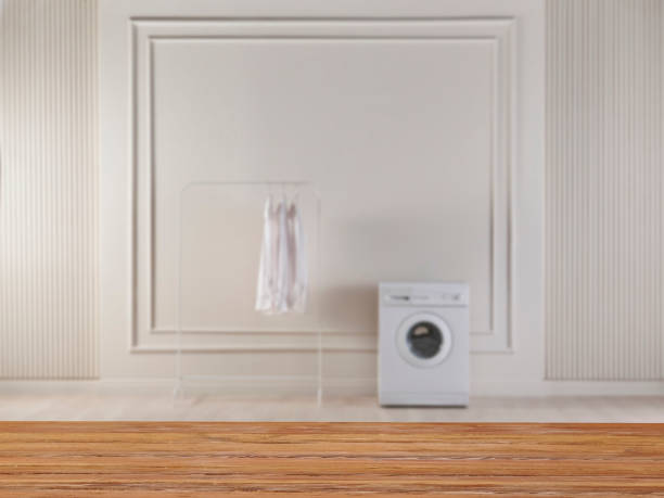 istock Blurred washing machine background and close up wooden table style. 1901665900