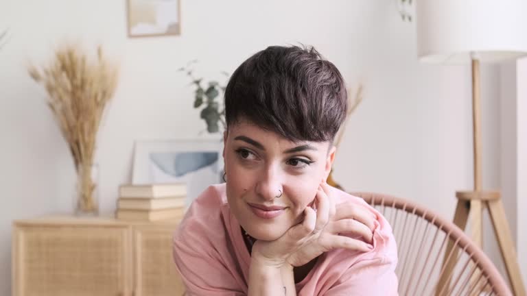 Woman with modern style enjoying a quiet evening at home, appreciating the silence after a long day at work.