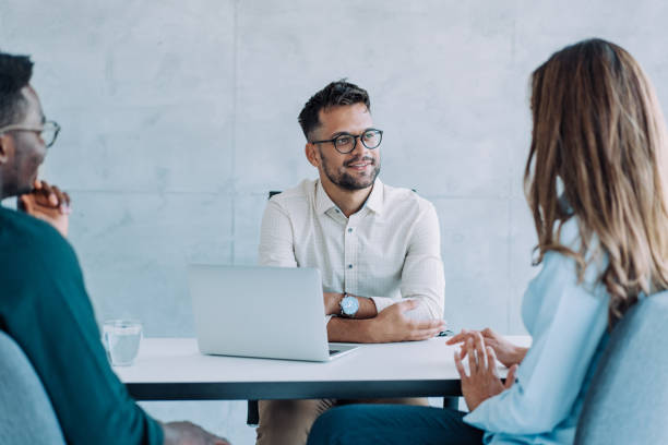 istock Group of business persons talking in the office. 1901675229