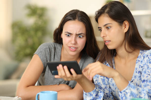 istock Shocked friends watching media on phone 1901686793