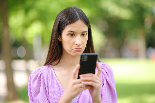 istock Perplexed woman checking strange news on phone 1901687315