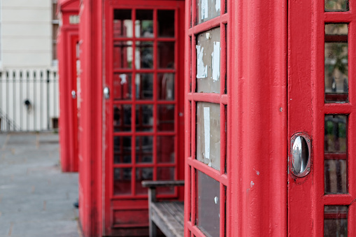 Close up of 2 vintage red telephone boxes, London