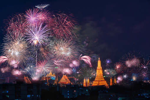 Happy new year 2024. Fireworks celebrate show for prople looking at Wat ArunTemple. Bangkok, Thailand - Jan 1, 2024