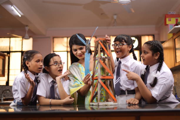 istock Secondary Or High School Students Studying Wind Turbines In Science Class With Teacher. 1901752595