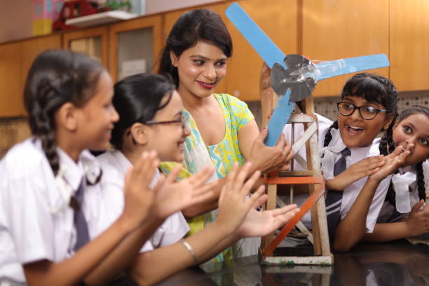 istock Science teachers explaining a handmade windmill project made by students in the laboratory. 1901752947