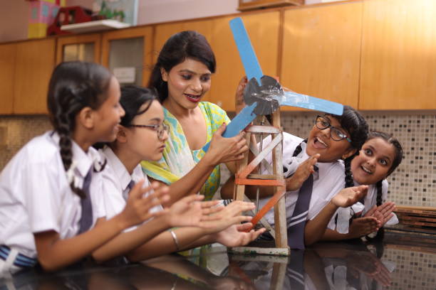 istock Science teachers explaining a handmade windmill project made by students in the laboratory. 1901753120