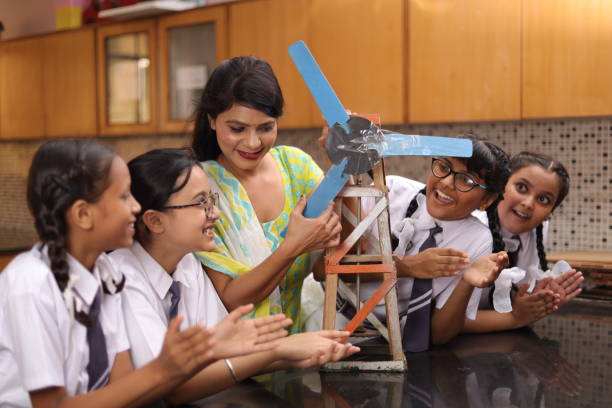 istock Science teachers explaining a handmade windmill project made by students in the laboratory. 1901753121