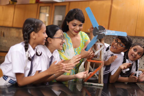 istock Science teachers explaining a handmade windmill project made by students in the laboratory. 1901753144
