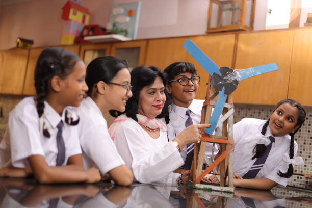 istock Secondary Or High School Students Studying Wind Turbines In Science Class With Teacher. 1901753652