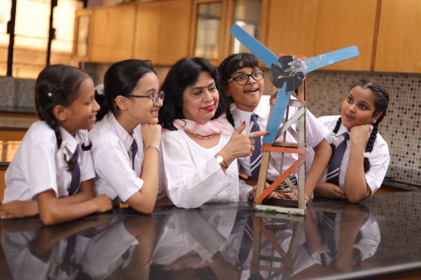 istock Secondary Or High School Students Studying Wind Turbines In Science Class With Teacher. 1901753663