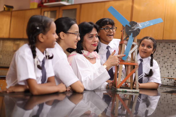 istock Secondary Or High School Students Studying Wind Turbines In Science Class With Teacher. 1901753664