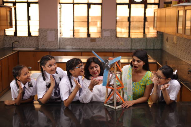 istock Science teachers explaining a handmade windmill project made by students in the laboratory. 1901756235