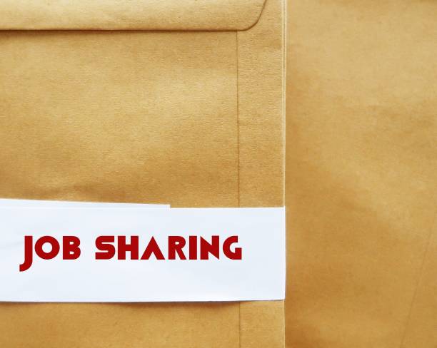istock Office envelope with text JOB SHARING, means two or more part-time workers perform the work of one full-time person, which is come back trend after pandemic 1901764576