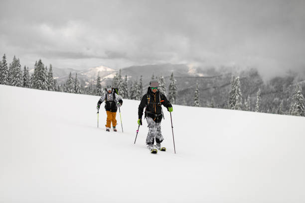 istock Two active skiers with backpacks walking on ski. Ski touring. 1901767174