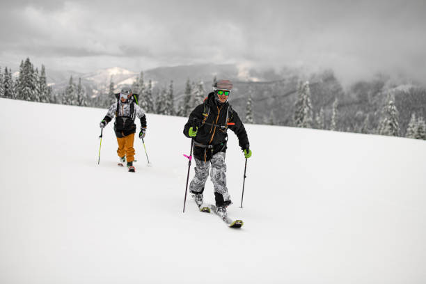 istock Two guys skiers with backpacks walking on ski. Ski touring. 1901768209
