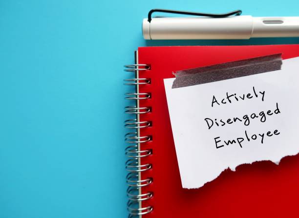 istock On blue copy space background, pen and torn paper on red norbook with handwritten text Actively Disengaged Employee - refers to unhappy employees who busy undermining workplace by getting others to share in their discontent 1901797156