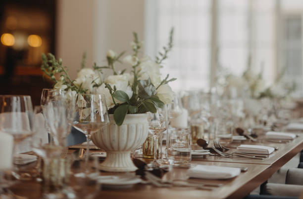 istock Elegant, romantic table setting for indoor wedding reception. Luxury wedding table decoration, special event table set up with fresh flowers arragements. 1901809895