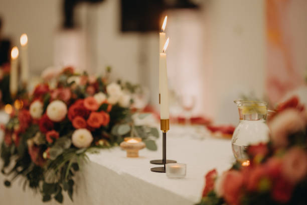 istock Elegant, romantic table setting for indoor wedding reception. Luxury wedding table decoration, special event table set up with fresh flowers arragements and high candlestick, candle holder. 1901809907