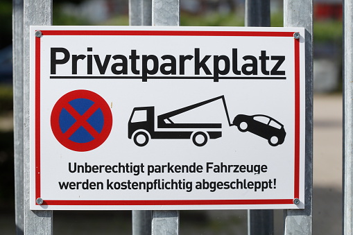 Private parking lot sign, unauthorized parking vehicles will be towed away for a fee, absolute stopping ban, traffic sign, Germany