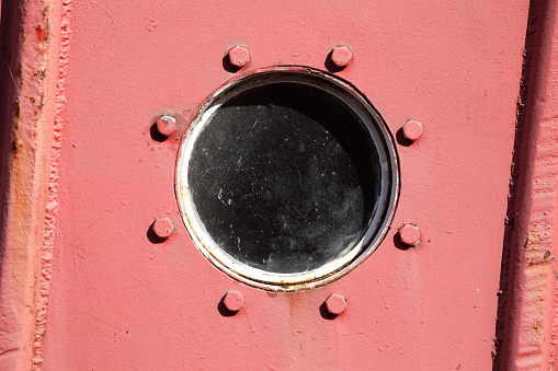 Porthole on an old red ship's side, Leer, East Frisia, Lower Saxony, Germany
