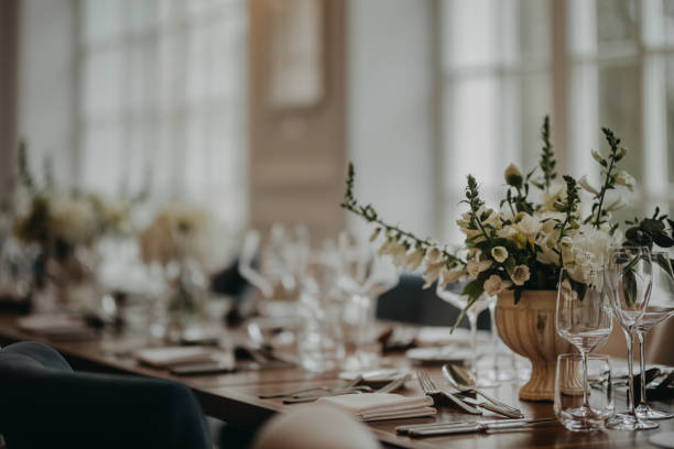 istock Elegant, romantic table setting for indoor wedding reception. Luxury wedding table decoration, special event table set up with fresh flowers arragements. 1901811997