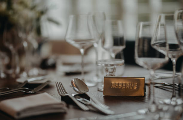 istock Reservation on table, reserved table sign, plate. Elegant, romantic table setting for indoor wedding reception. or for restaurant. 1901812508