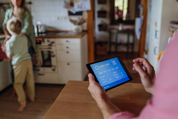 istock Man using smart thermostat, adjusting, lowering heating temperature at home. Concept of sustainable, efficient, and smart technology in home heating and thermostats. 1901814084